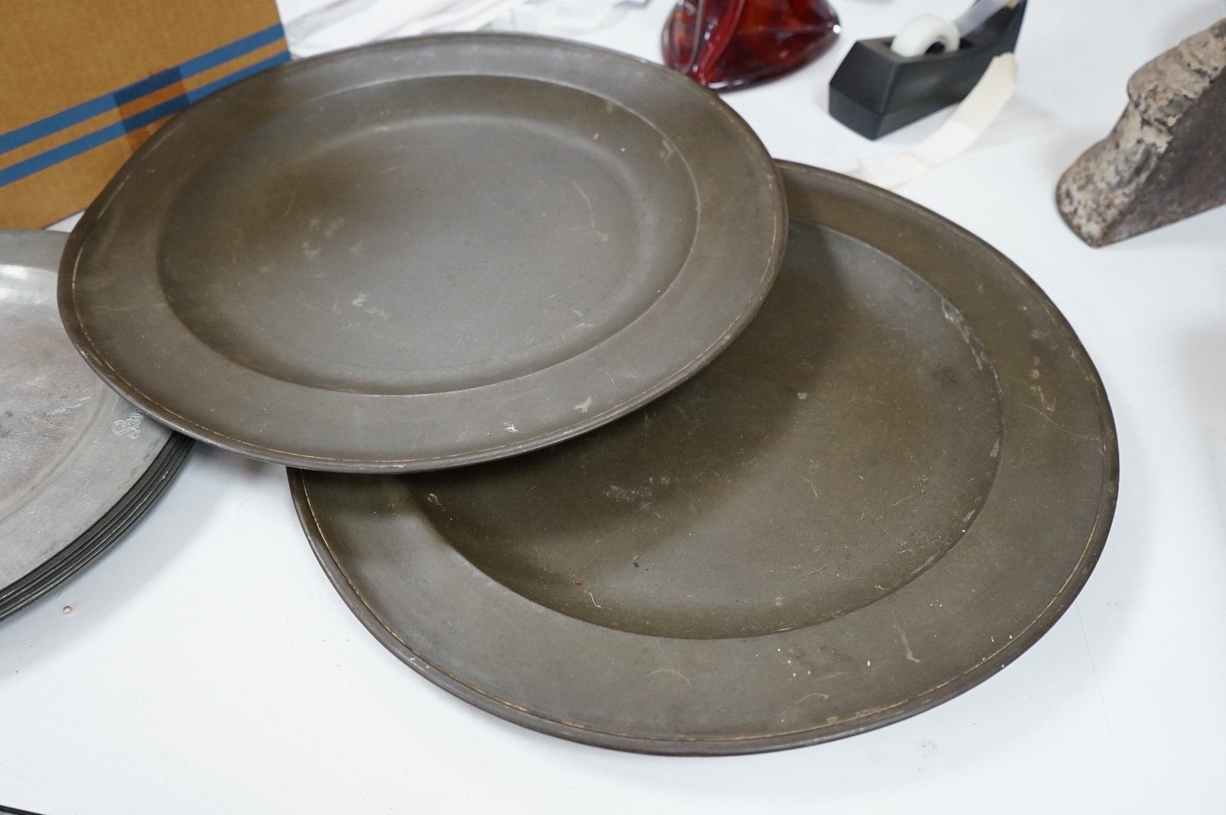 Two 19th century pewter chargers and a set of six pewter plates, largest 42cm in diameter